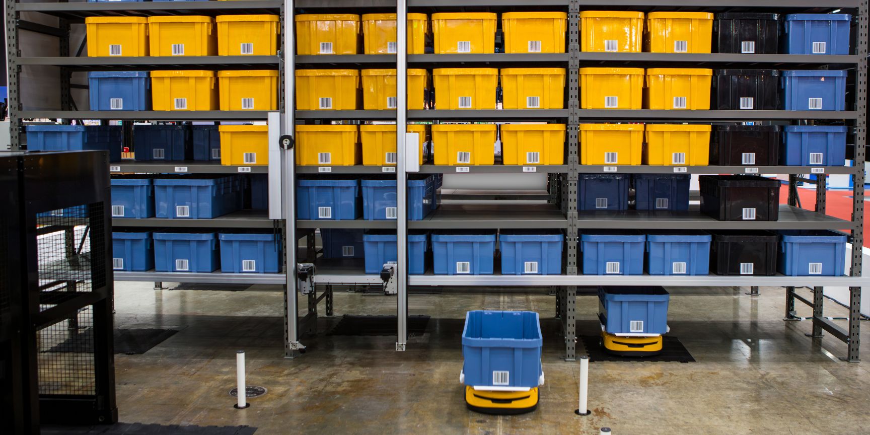 Close-up of a shuttle autonomously moving a blue storage container in a state-of-the-art logistics center, symbolizing precision and speed in automated warehousing.